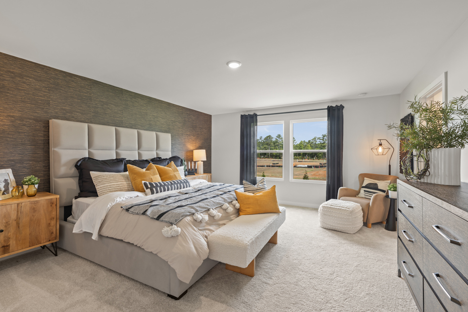 A bedroom with a bed and a couch.