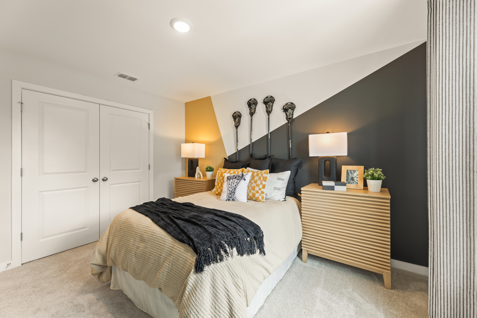 A bedroom with a bed and lamps.