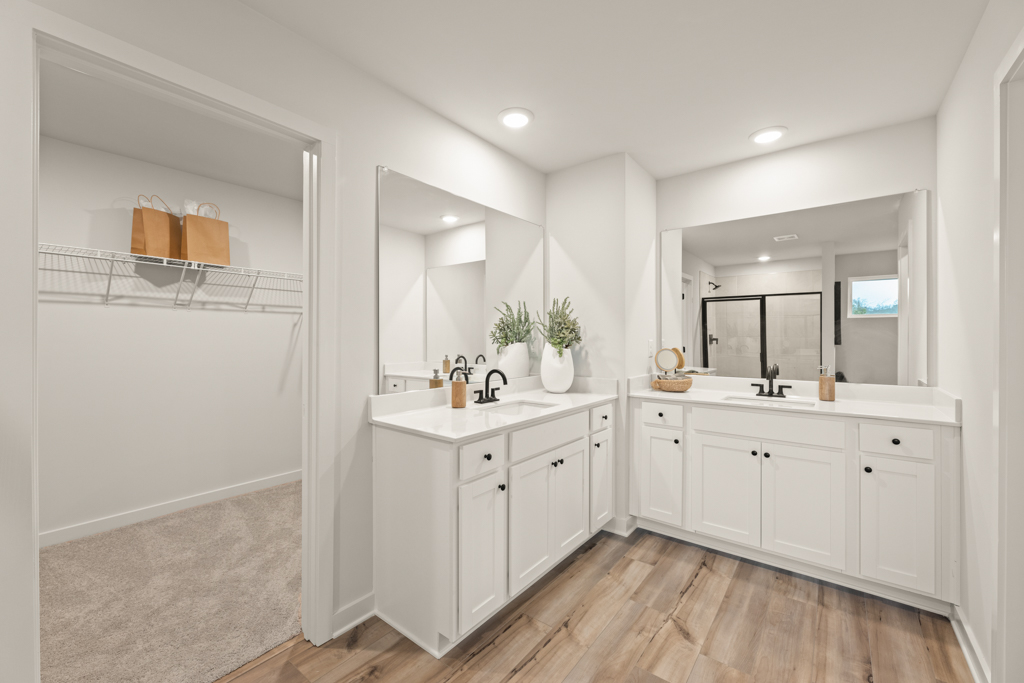 A bathroom with white cabinets.