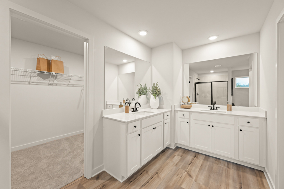 A bathroom with white cabinets.