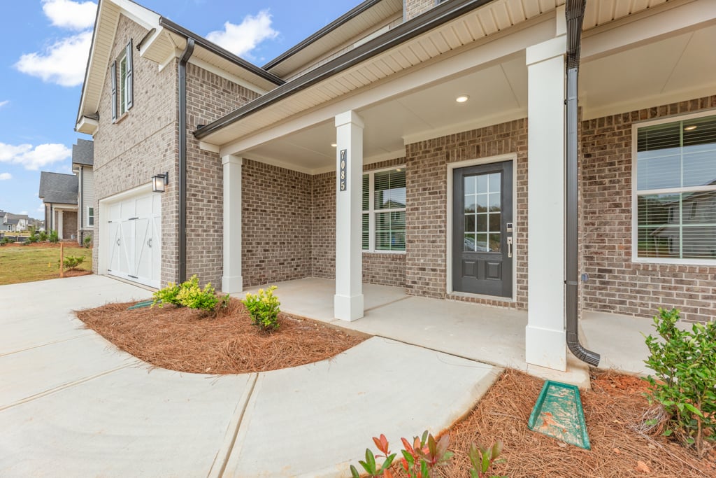 A house with a brick driveway.