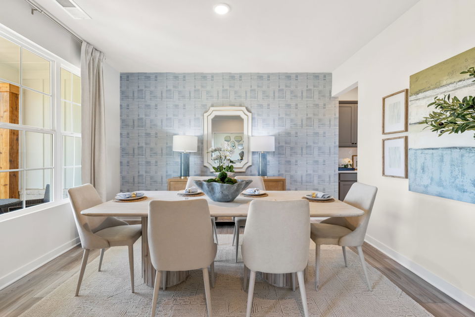 A dining room with a round table.