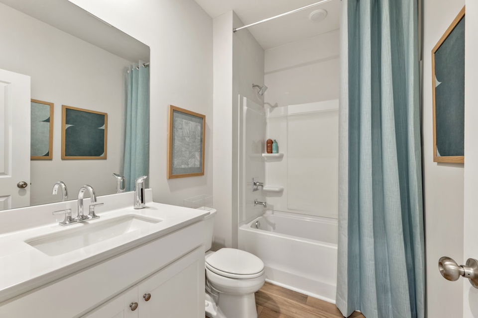 A bathroom with a sink toilet and shower.