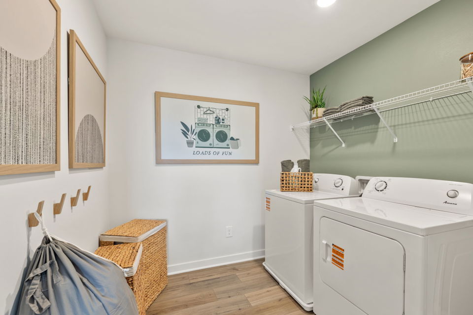 A white laundry room with a washer and dryer.