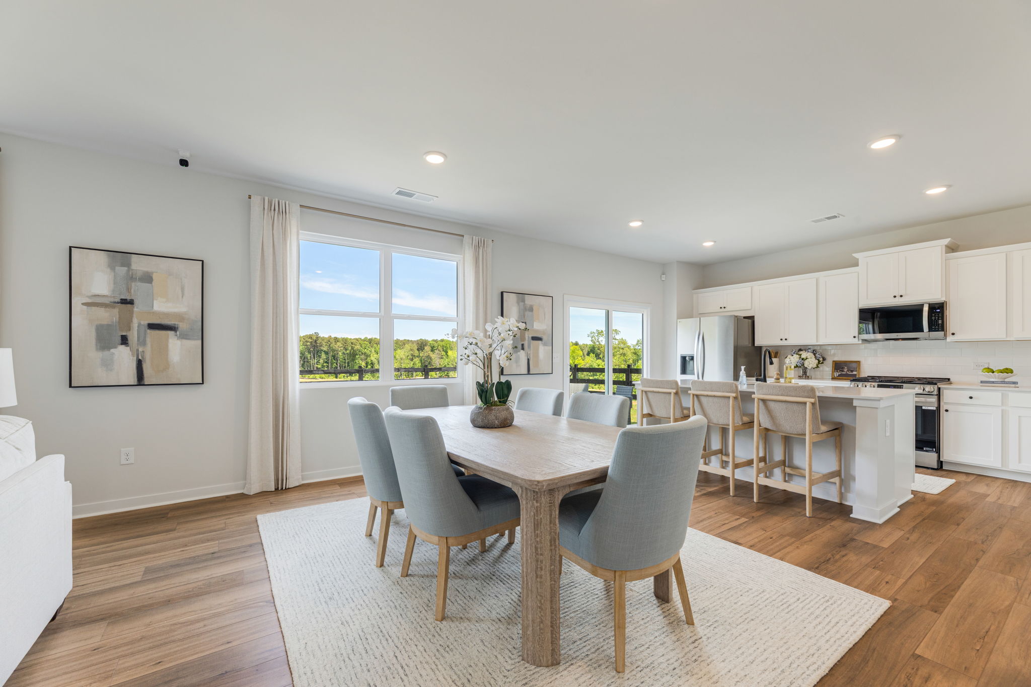 A large kitchen with a dining table.