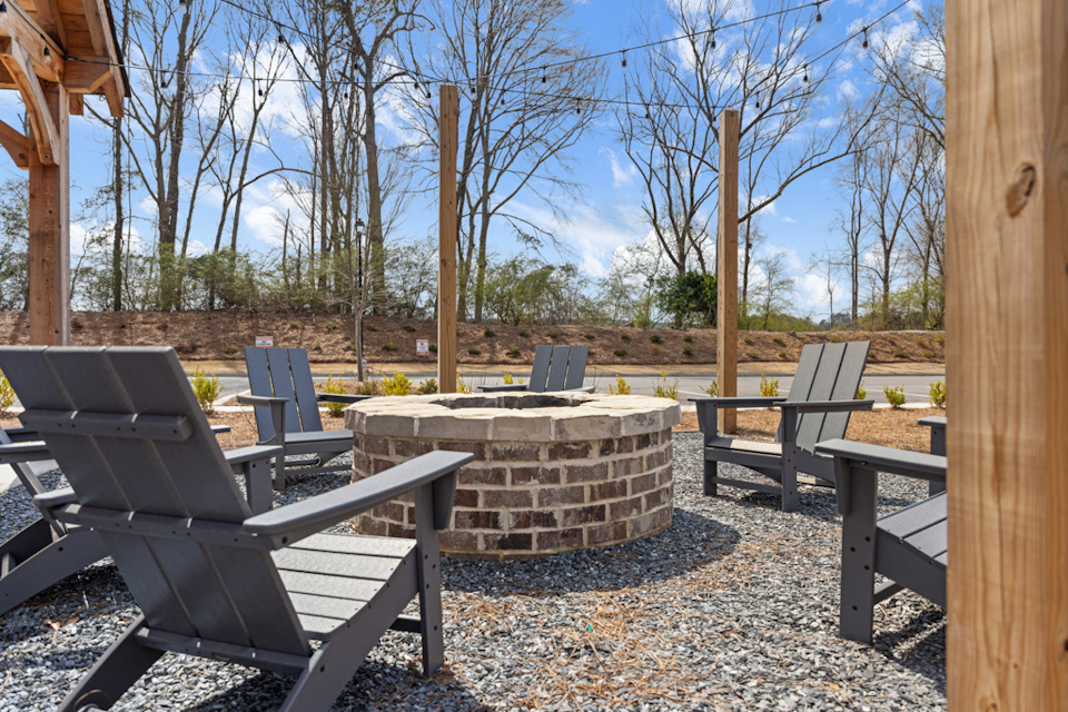 A group of chairs and a table outside.