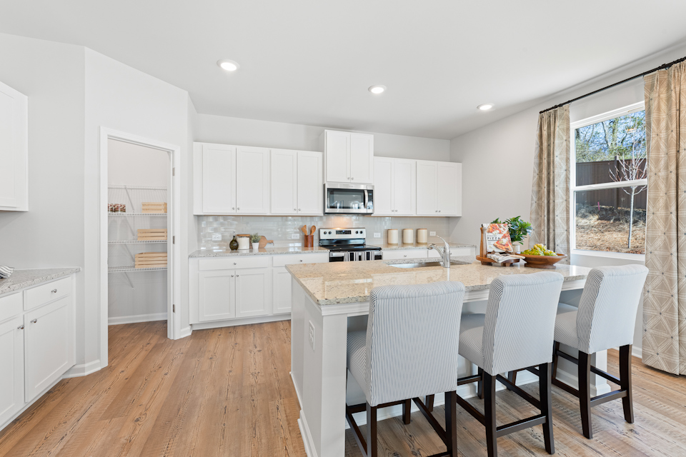 A kitchen with white cabinets.
