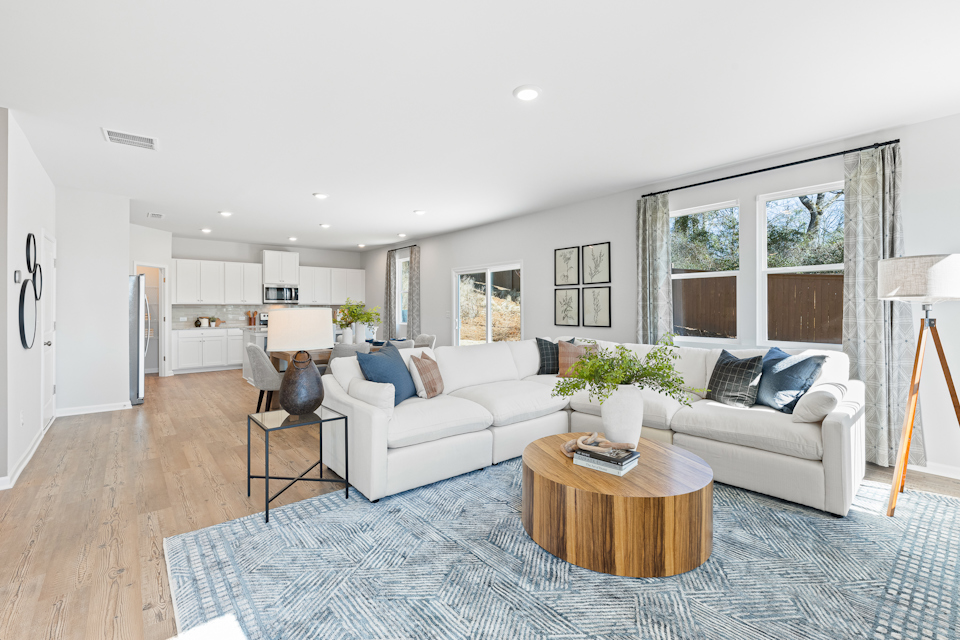 A living room with a rug and a table.