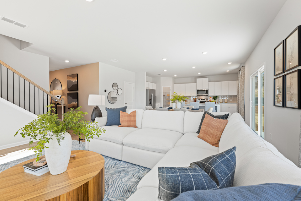A living room with a white couch and a table.