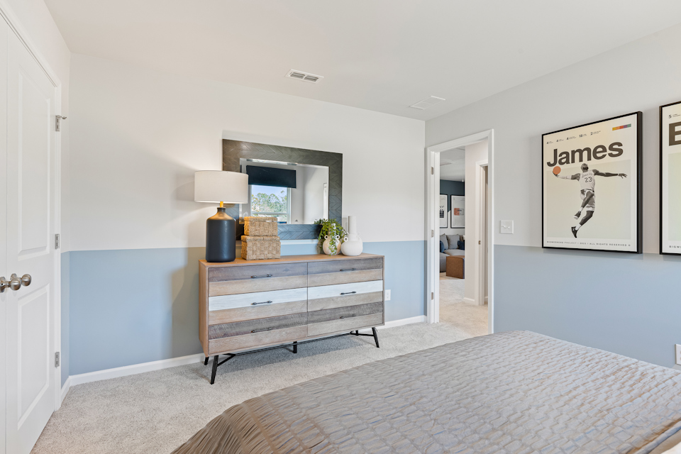 A room with a bed and a bench.