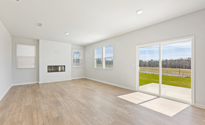 A room with a wood floor and a large window.