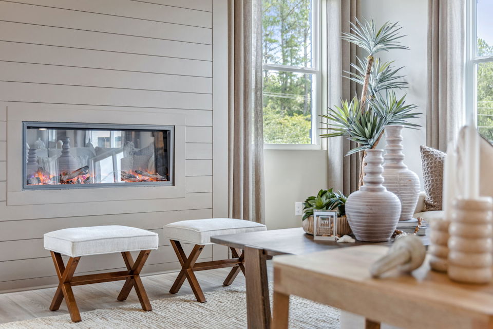 A living room with a table and chairs.