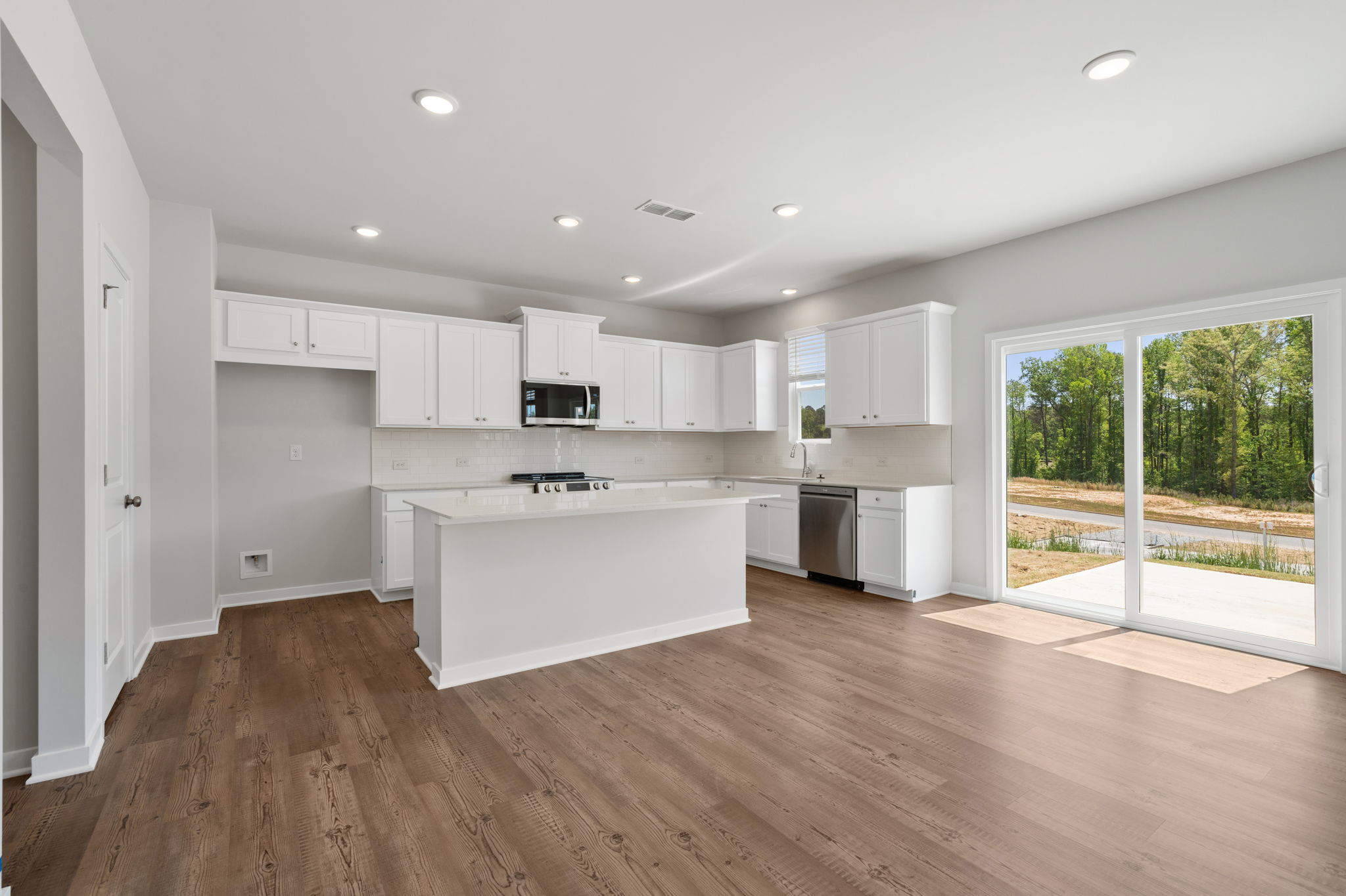A kitchen with white cabinets.