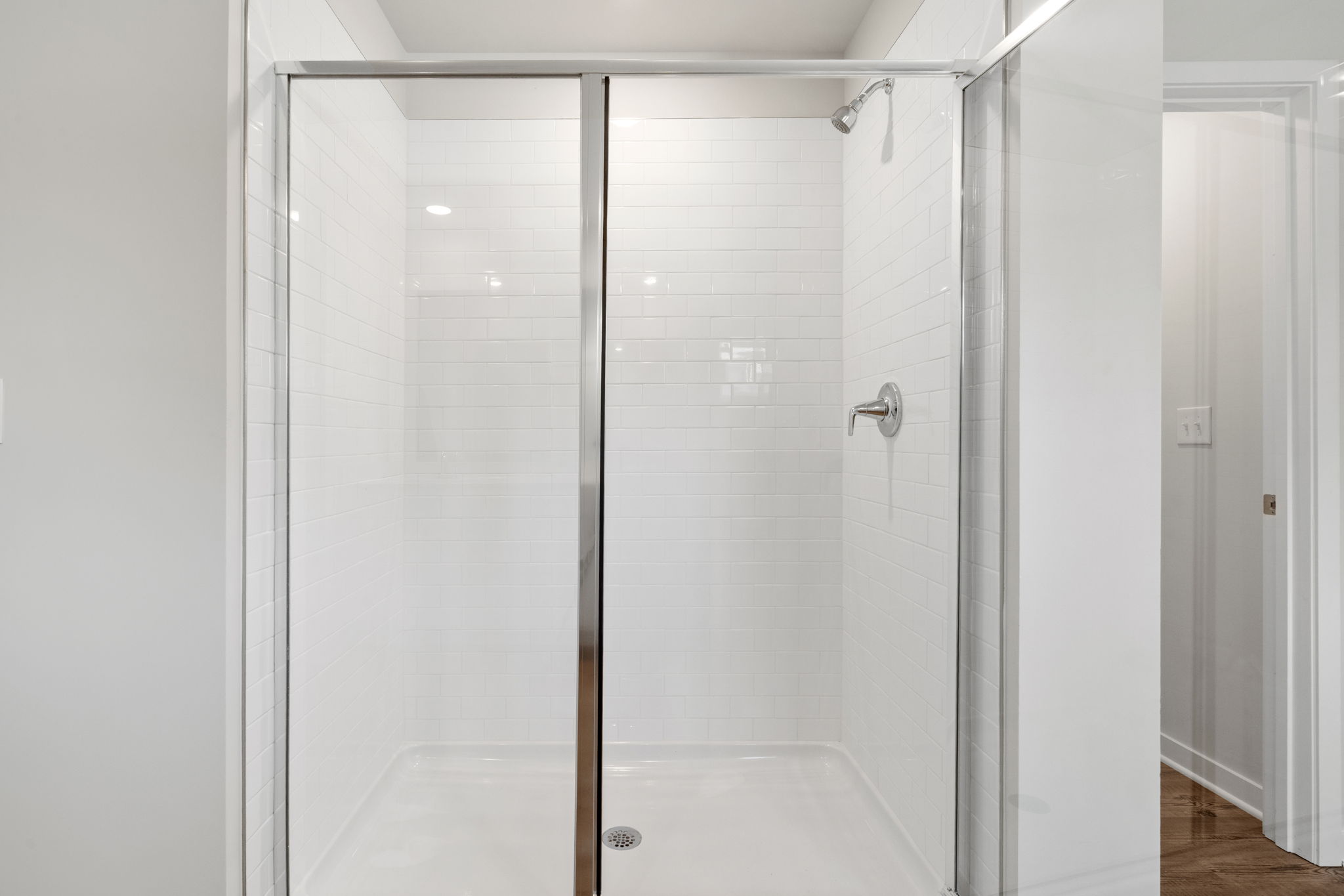 A bathroom with a shower unit.