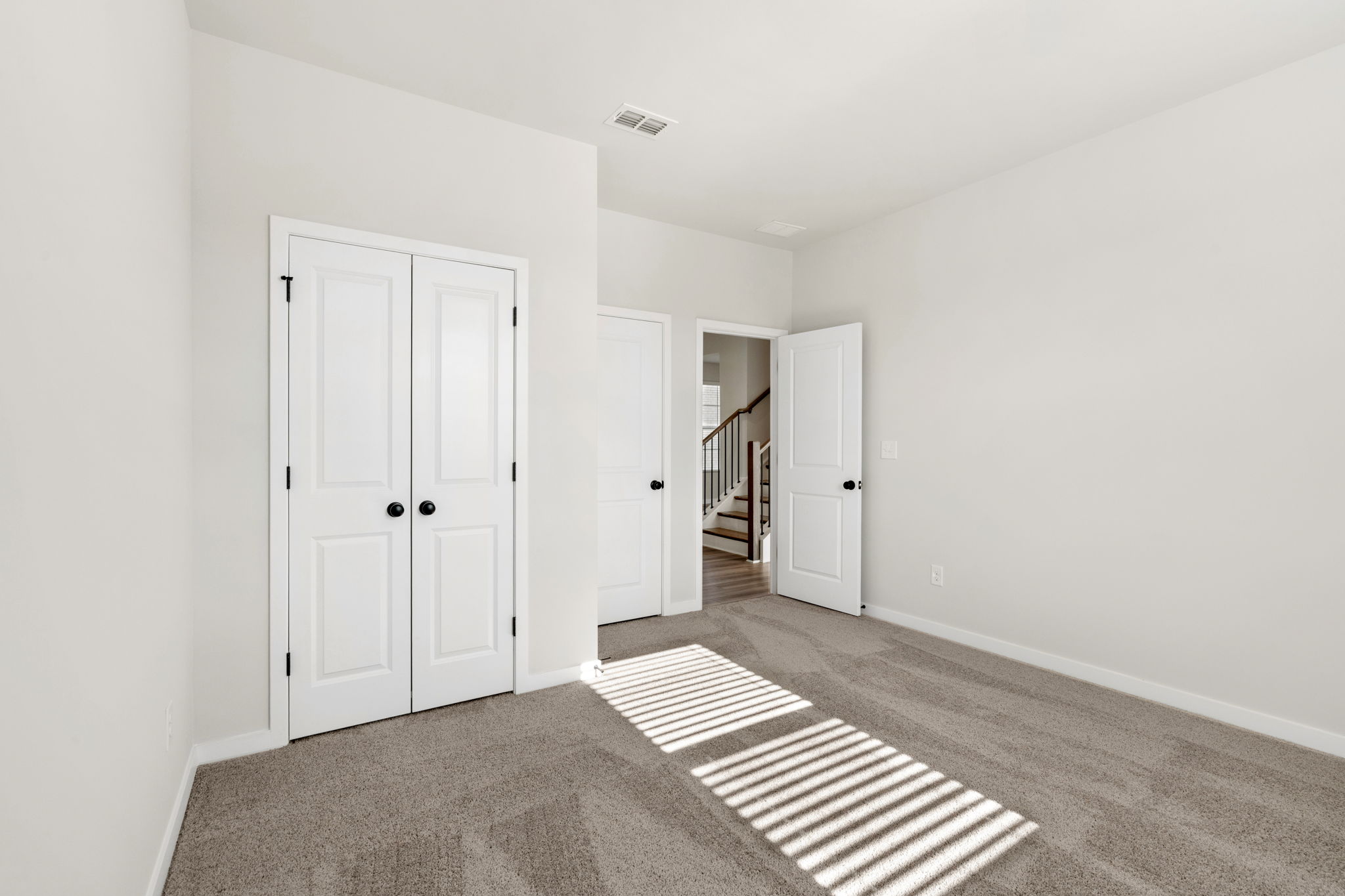 A hallway with white doors.