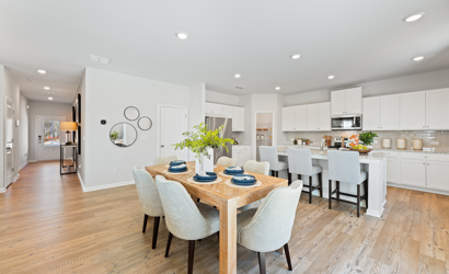 A large kitchen with a dining table.