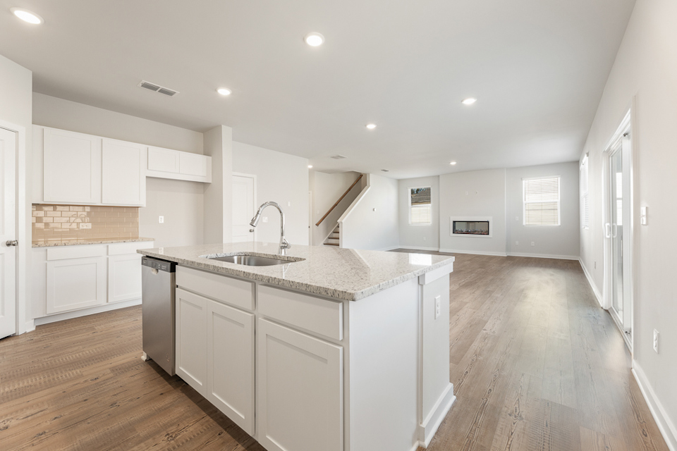 A kitchen with white cabinets.