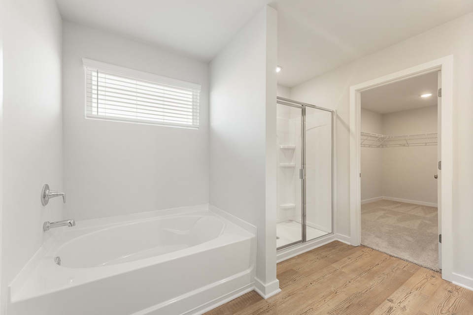 A bathroom with a tub and shower.