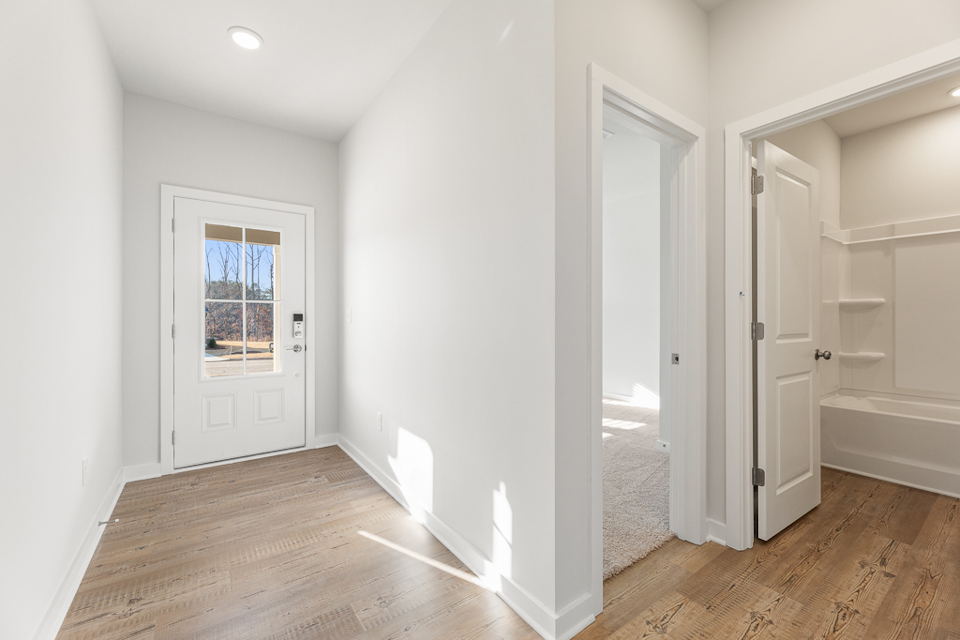 A room with white walls and a wood floor.