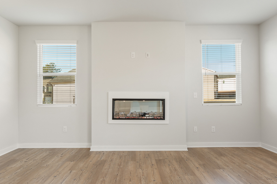 A room with windows and a wood floor.