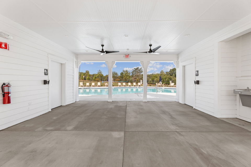 A room with white walls and a large window.