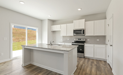A kitchen with white cabinets.