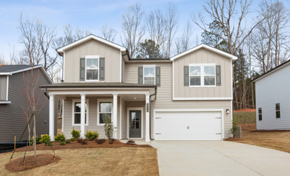 A white house with a garage.