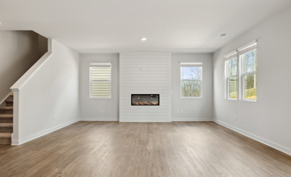A room with a fireplace and windows.