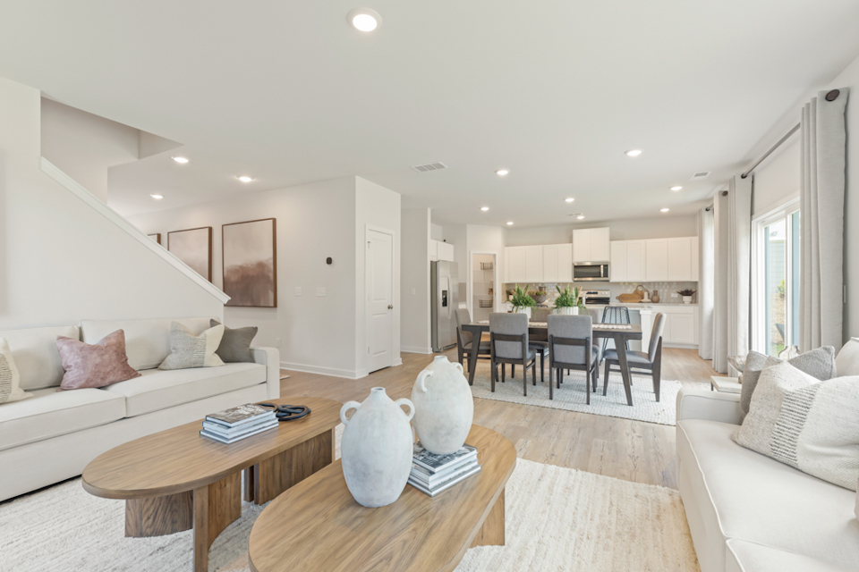 A living room with a table and chairs.