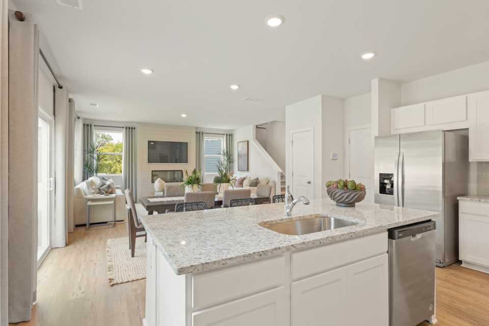 A kitchen with white cabinets.