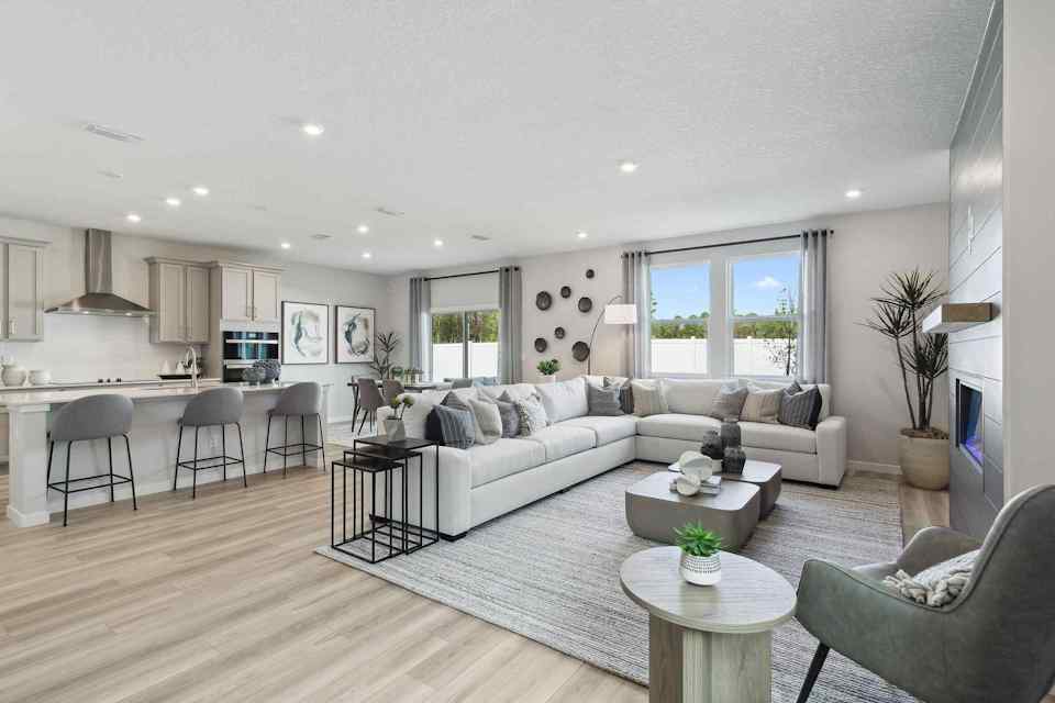 A large living room with a large white couch and a table.