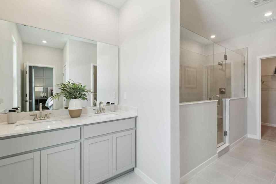 A bathroom with white cabinets.
