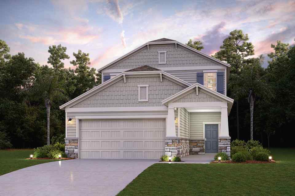 A house with a driveway and trees.