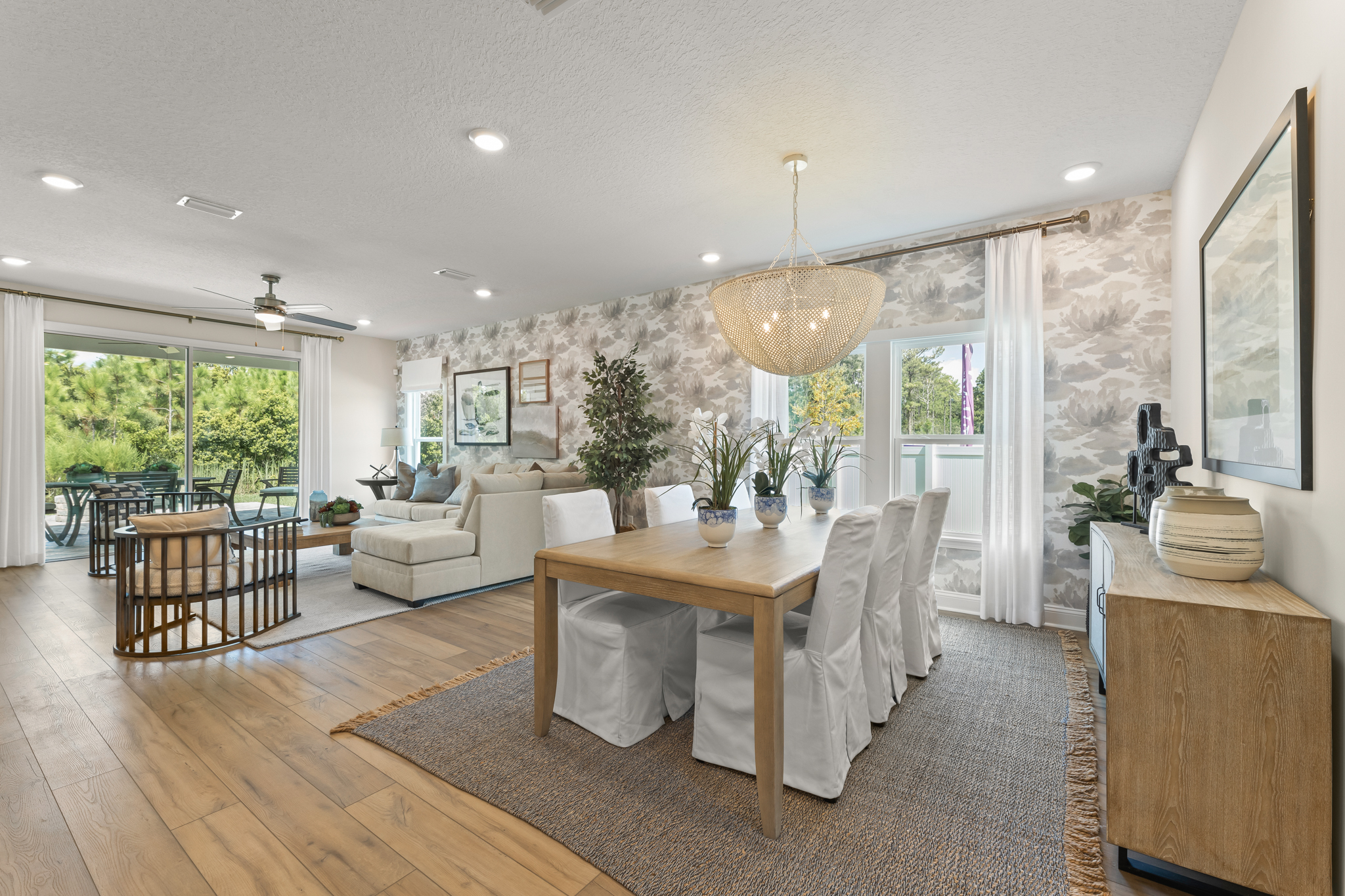 A large living room with a dining table and chairs.