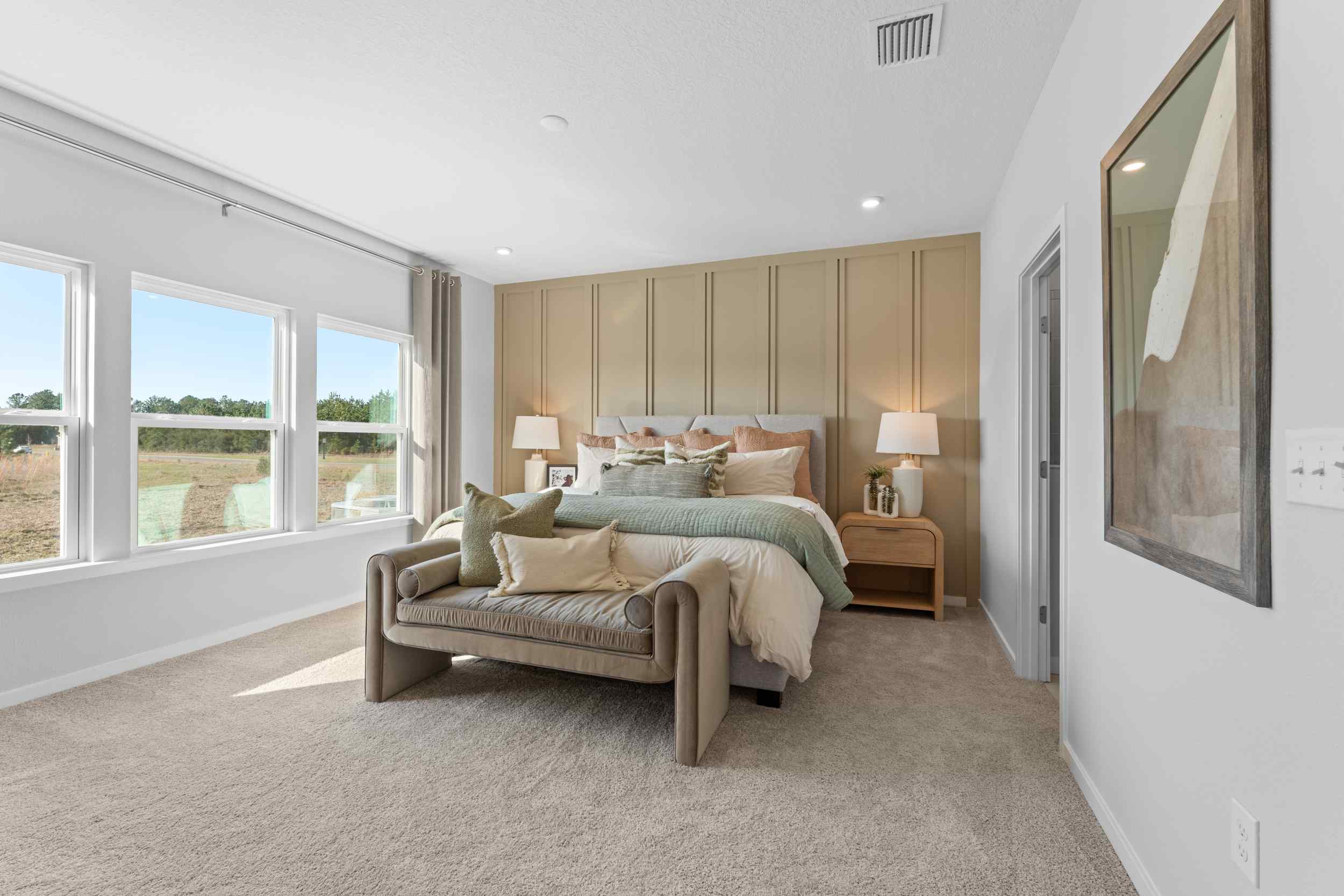 A bedroom with a bed and a mirror.