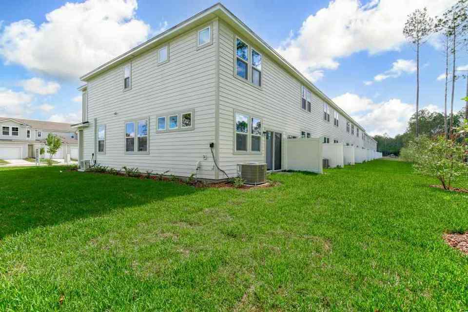 A white house with a green lawn.