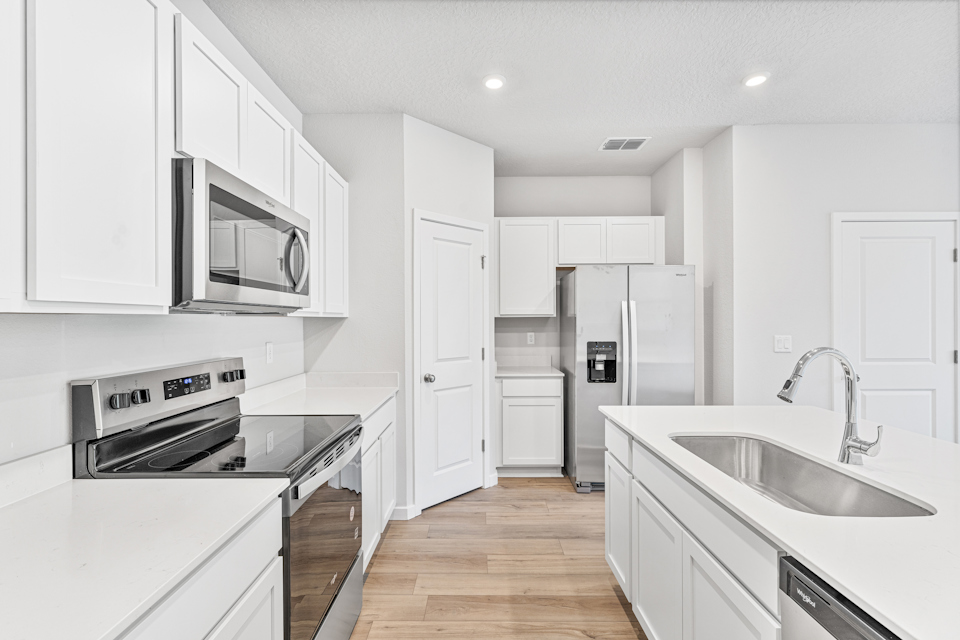 Lot 19 Townhome Kitchen with White Cabinets at The Villas at Bishop Oaks