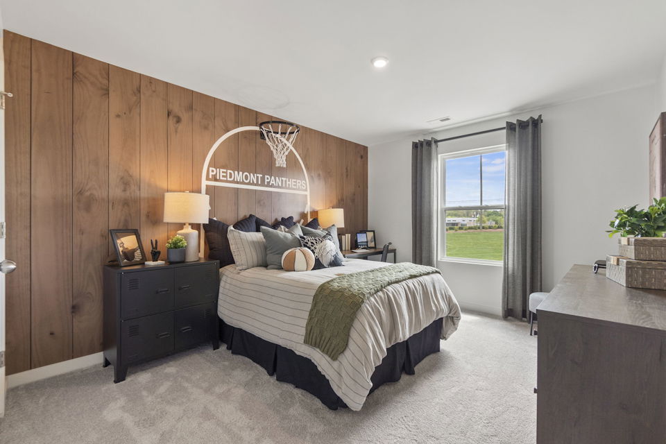 A bedroom with a bed and a desk.