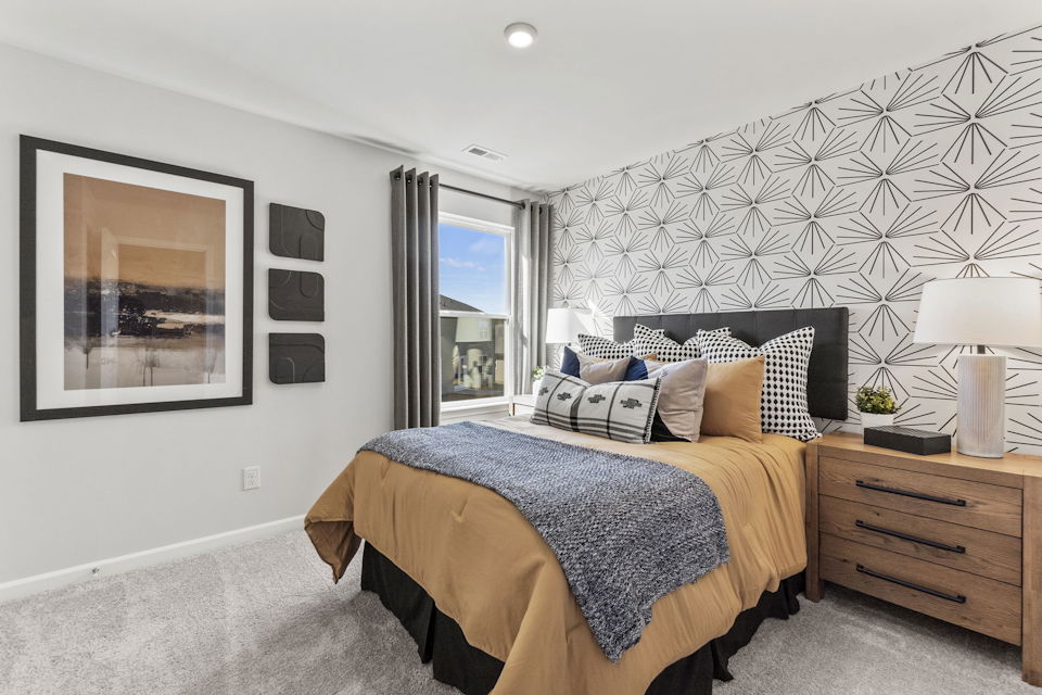 A bedroom with a bed and a window.