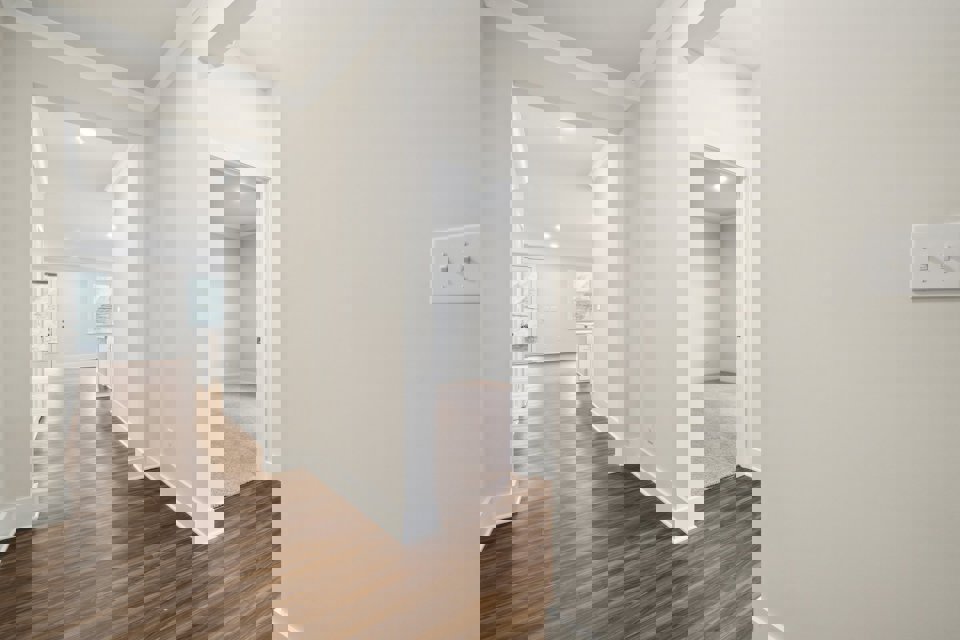 A hallway with white walls.