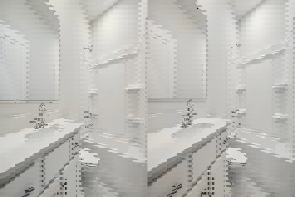 A bathroom with a tub sink and toilet.