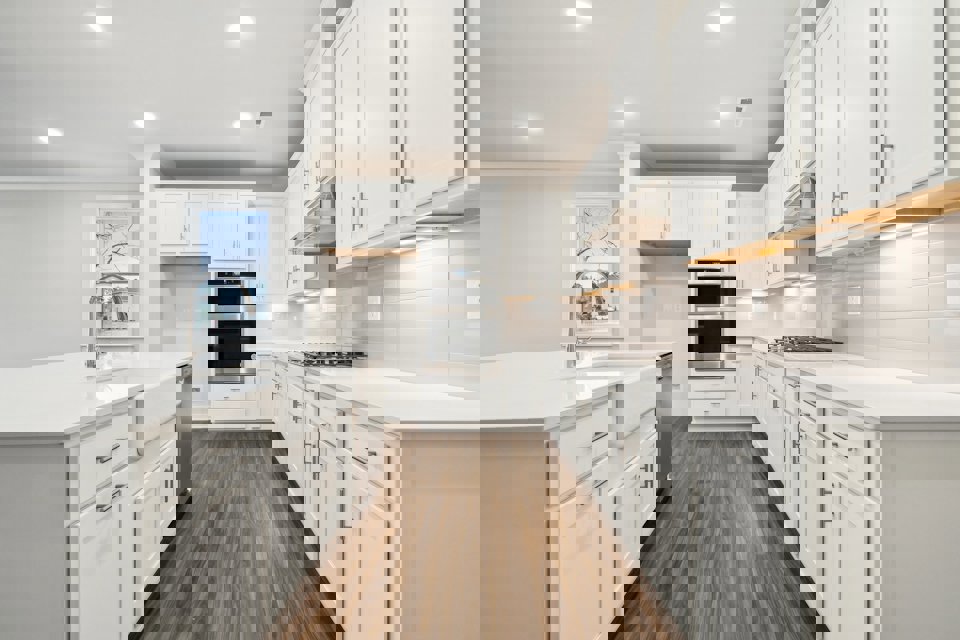 A kitchen with white cabinets.