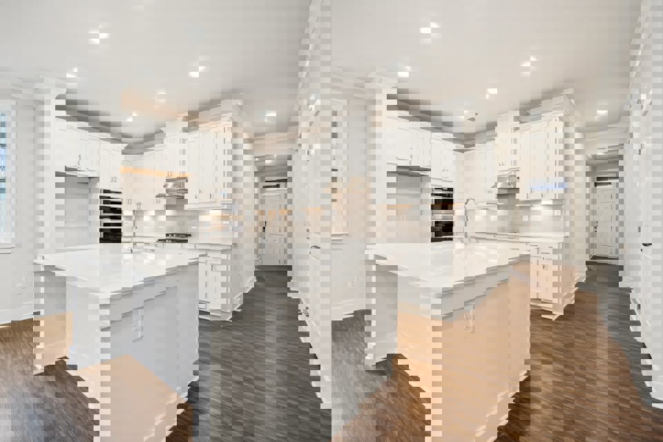 A kitchen with white cabinets.