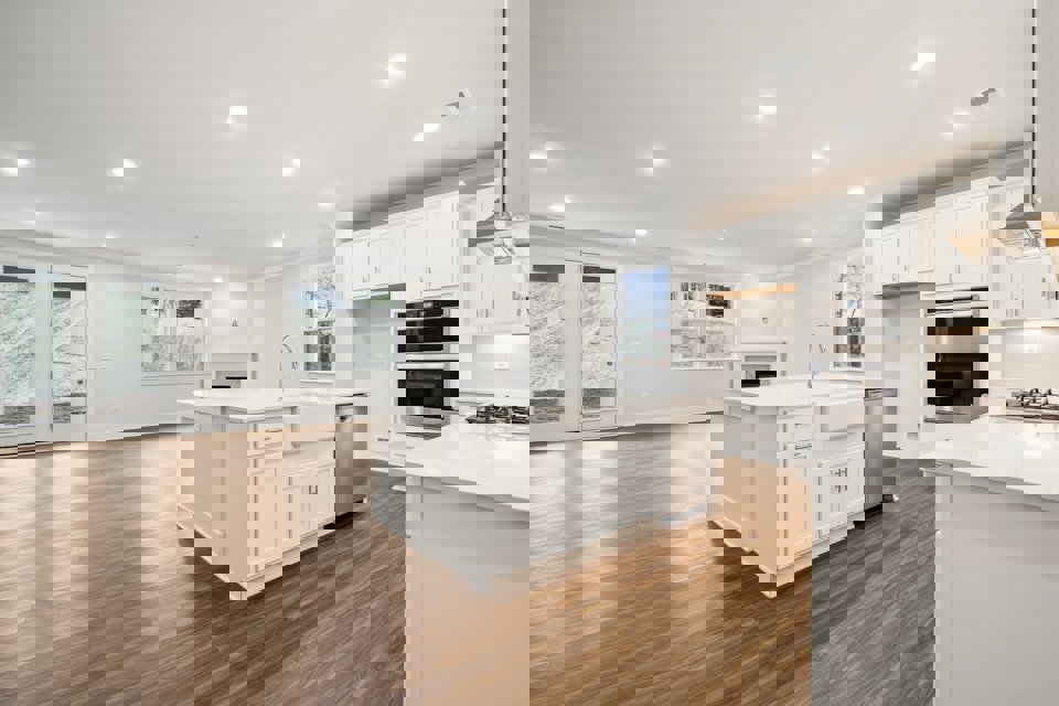 A kitchen with white cabinets.