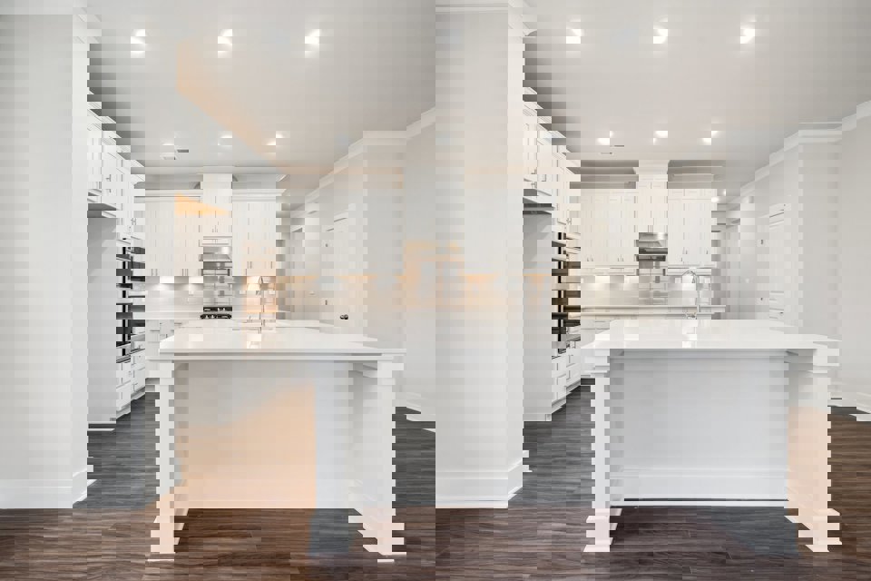 A kitchen with white cabinets.