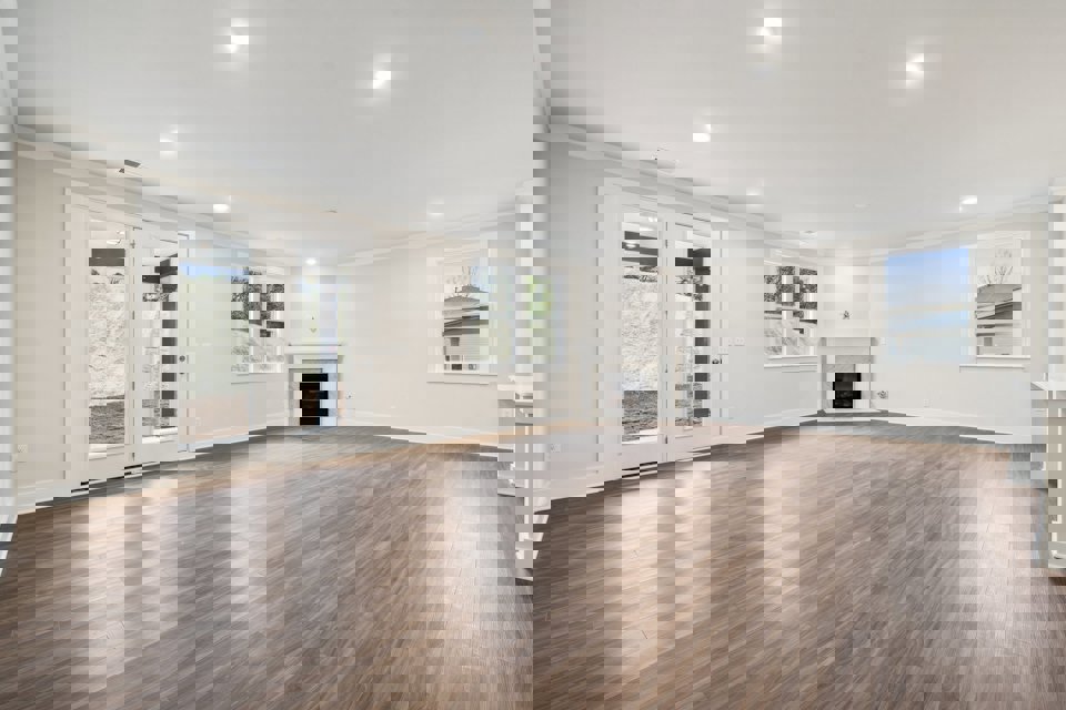 A large empty room with a fireplace.