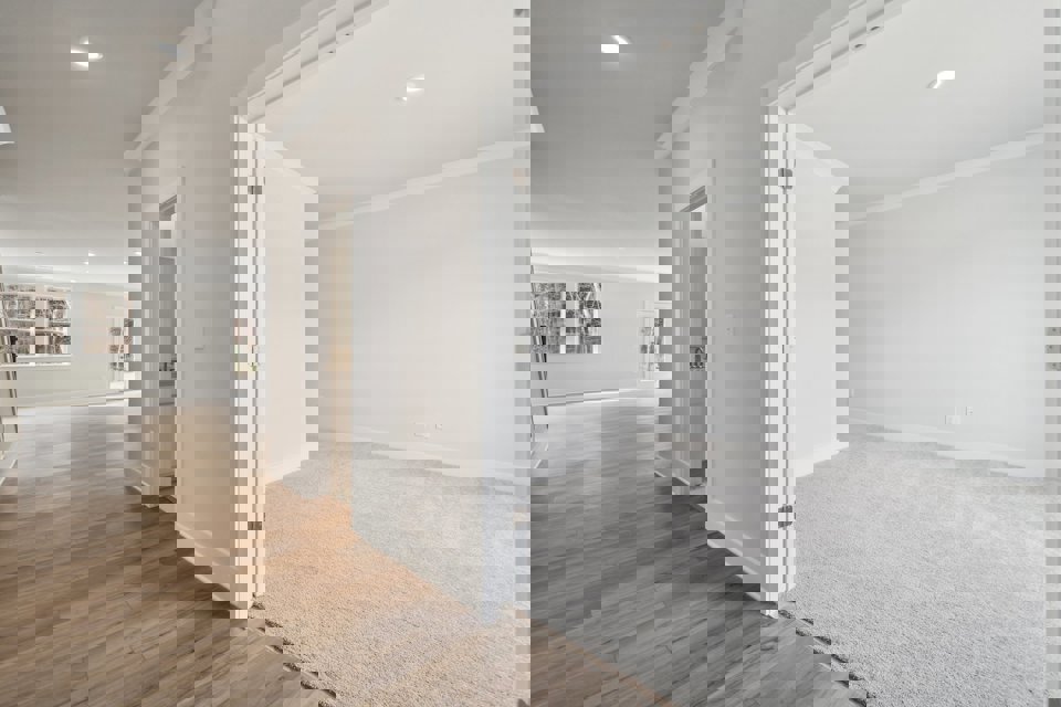 A room with a wood floor and white walls.