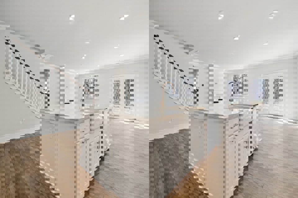 A kitchen with white cabinets.