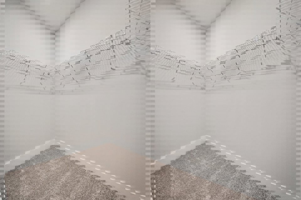 A white wall with a metal railing.