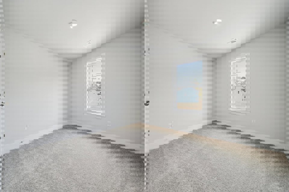 A room with a window and a carpet.